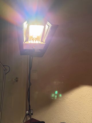 Escritorio de madera con silla de ratán y lampara