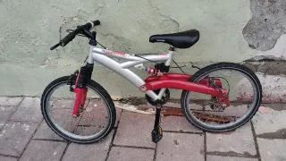 Bicicleta infantil con suspensión roja y plateada