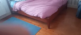 Cama de madera y metal, cabecero incorporado.