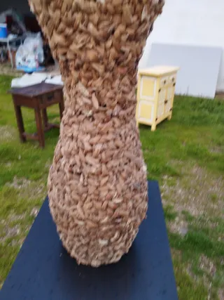 Jarrón de rafia con flores decorativas