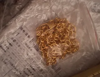 Bolso de mano dorado con hoja