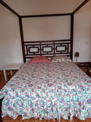 Cama con dosel de madera y tela