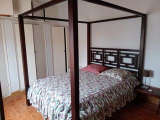 Cama con dosel de madera y tela