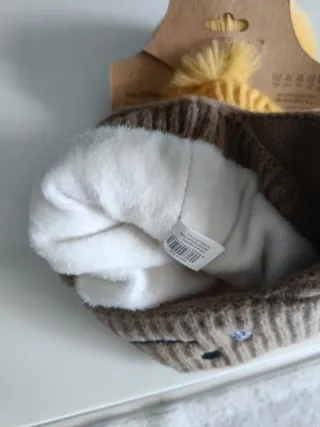 Berretto per bambini con pompon e paraorecchie