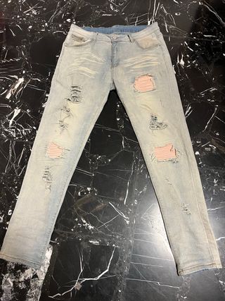 Jeans azzurri con strappi rosa. taglia 32 american