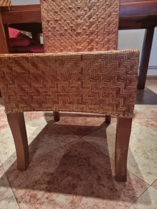 Mesa comedor madera y sillas de mimbre.