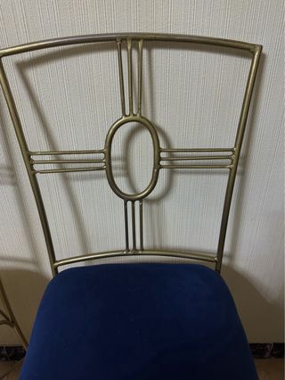 Juego de 2 sillas doradas con asiento azul.