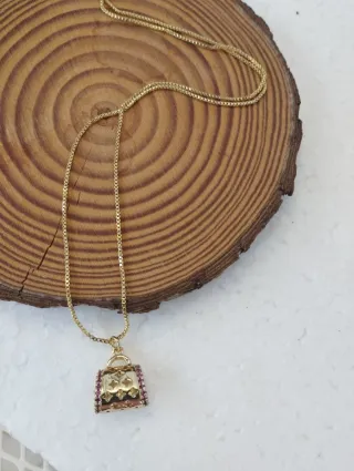 Colgante nuevo bolso dorado con piedras rosas