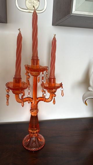 Candelabro de cristal naranja con velas