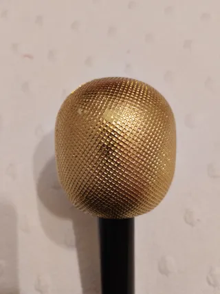 Micrófono de juguete dorado