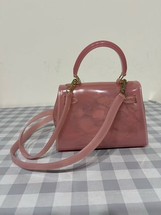 Borsetta trasparente in gomma rosa con scritte