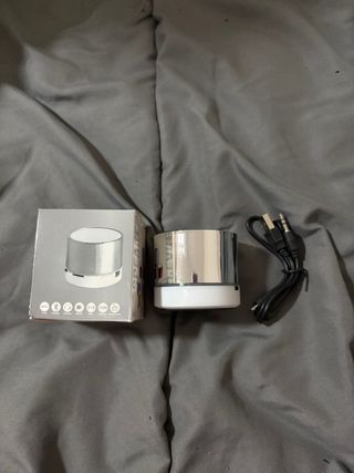 Altavoz Bluetooth plateado y blanco