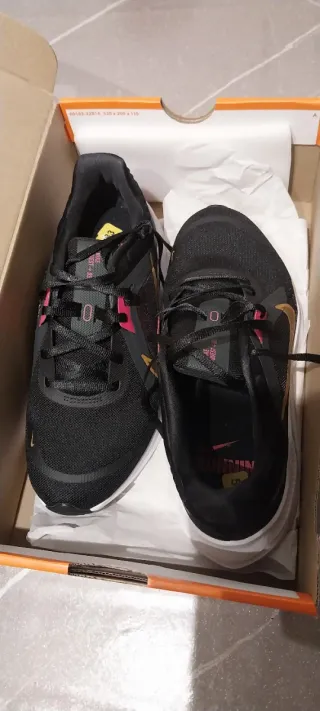 Scarpe sportive Nike nere e baffo dorato