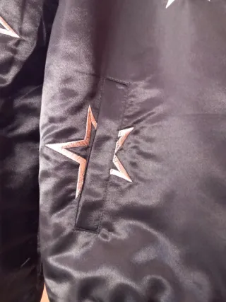 Cazadora bomber negra con estrellas.