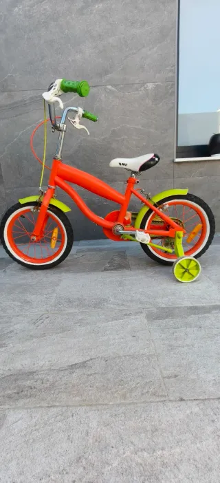 Bicicleta de 14" infantil naranja y verde.