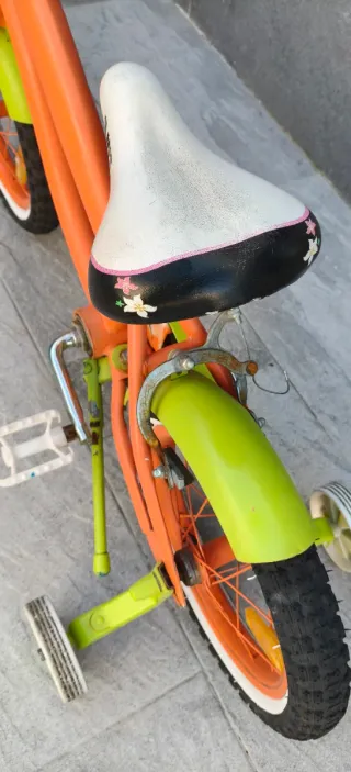Bicicleta de 14" infantil naranja y verde.