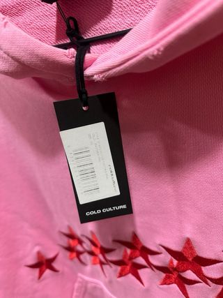 Sudadera cold culture rosa con estrellas rojas.