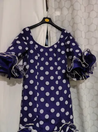 Traje de flamenca morado con lunares blancos.