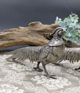 Coppia statue metallo argentato anni '70