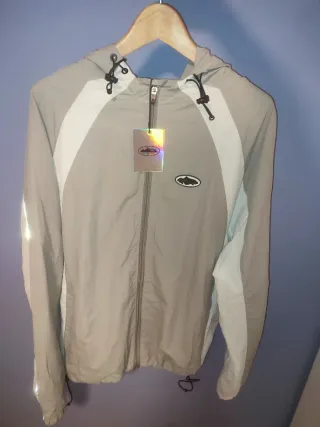 Cortavientos Corteiz gris y blanco