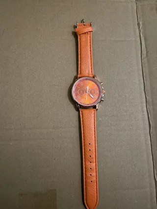 Reloj de pulsera naranja y dorado