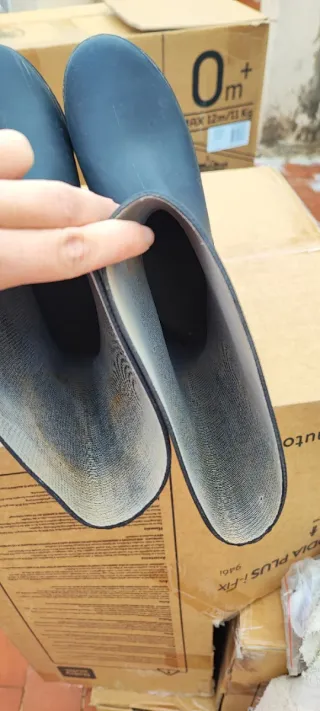 Botas de agua negras usadas una única vez.