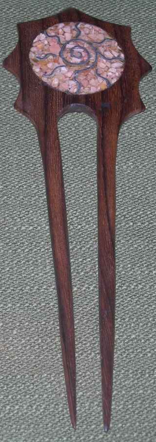 Fermacapelli con decoro solare