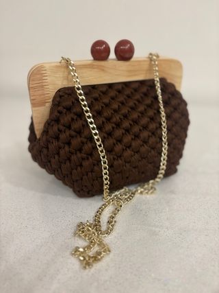 Clutch uncinetto con chiusura a sfera