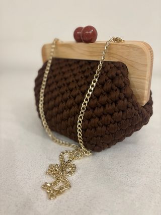 Clutch uncinetto con chiusura a sfera