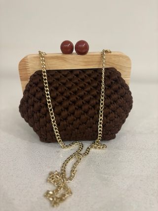 Clutch uncinetto con chiusura a sfera