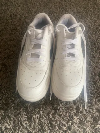 Zapatillas blancas sencillas para mujer.