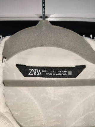 Blusa blanca con detalle de plumas