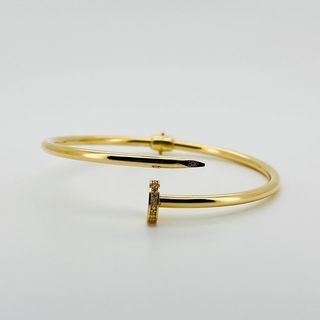 PULSERA RIGIDA CLAVO CON CIRCONITAS. Oro 18k. Peso