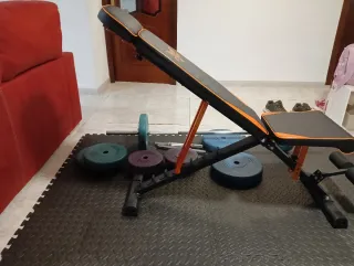 Banco de ejercicios con barra y mancuernas