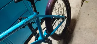 Bicicleta BMX azul con manillar morado