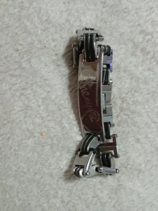 Lote coleccionista: mechero, moneda y pulsera.