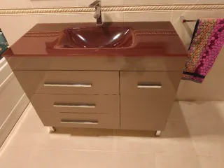 Mueble de baño con lavabo y grifo.