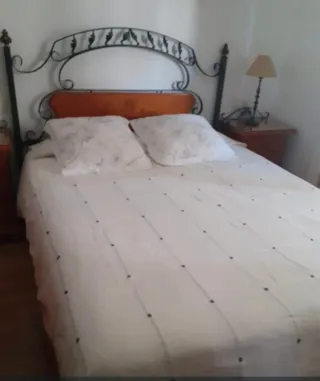 Dormitorio de madera y forja.