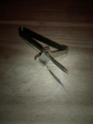 Pinza per servire pollo in acciaio.