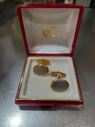 Gemelos dorados con piedra gris