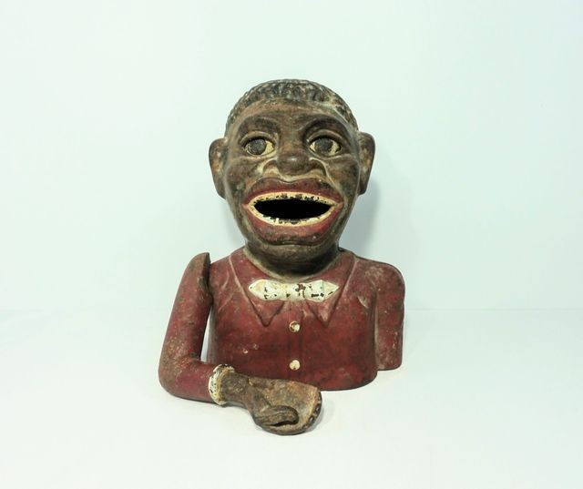 Antigua hucha de hierro Jolly Nigger Bank.
