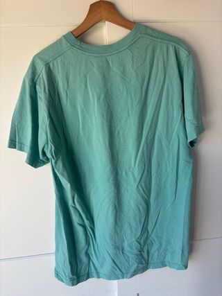 Camiseta DC color verde azulado con bolsillo