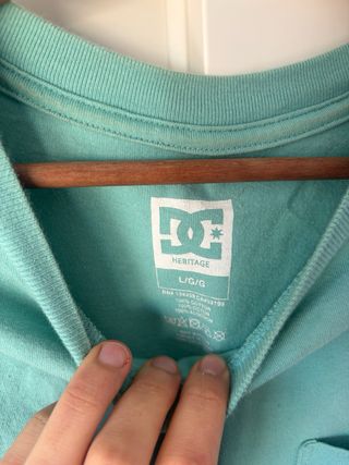 Camiseta DC color verde azulado con bolsillo