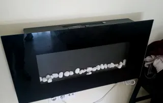 Chimenea eléctrica negra con piedras