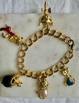 Pulsera dorada con charms de gatos y más
