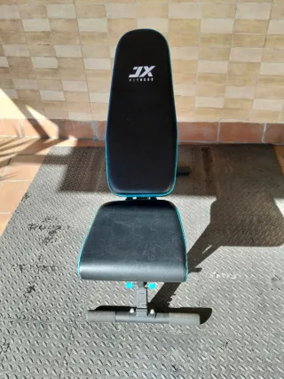 Banco de pesas con barra y discos