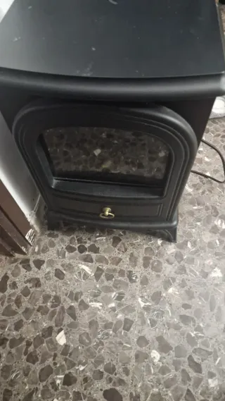 Estufa efecto chimenea negra con detalles dorados