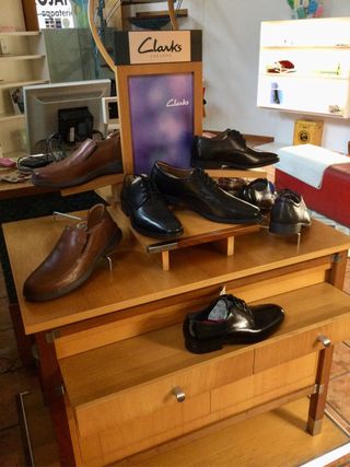 Mesa expositora de calzado Clarks.