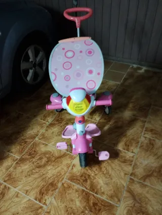 Triciclo infantil rosa con toldo