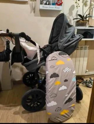 Carrito de bebé gris con funda